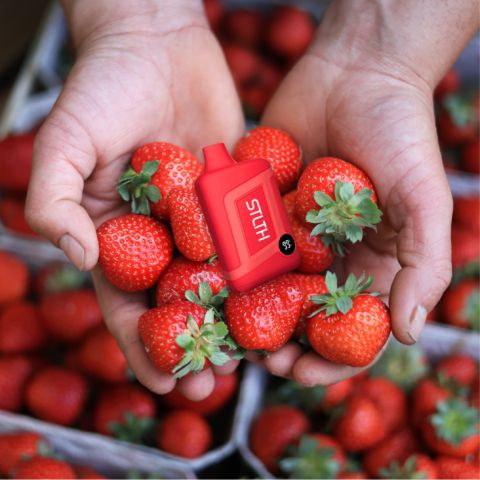 A person holding strawberries in their hands.