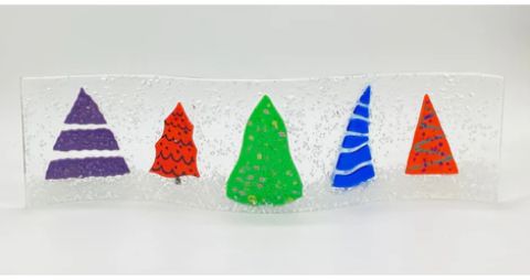 A christmas tree shaped glass vase with colorful trees on it.