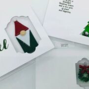 A set of christmas cards with a gnome and a santa claus.