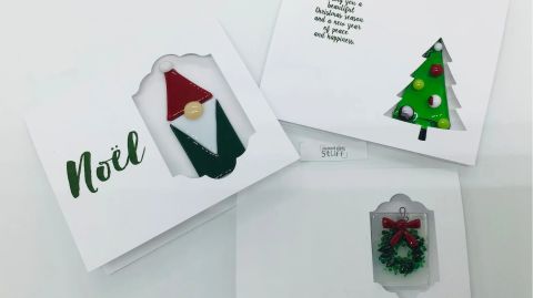 A set of christmas cards with a gnome and a santa claus.