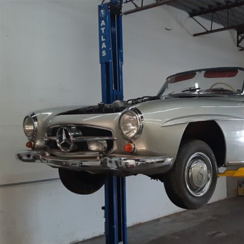Mercedes-benz 300sl in a garage with a lift.