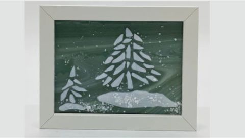 A white frame with a snowy scene on it.