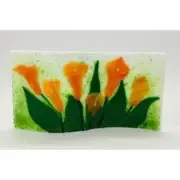 Decorative glass panel depicting orange calla lilies with green leaves on a speckled background, displayed upright.
